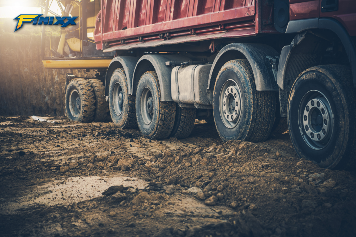 "Close-up of rugged truck tires on a cargo truck, highlighting durability and traction on the road."